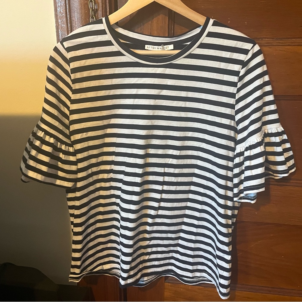 Aftermarket Size L shirt with ruffles on sleeve.